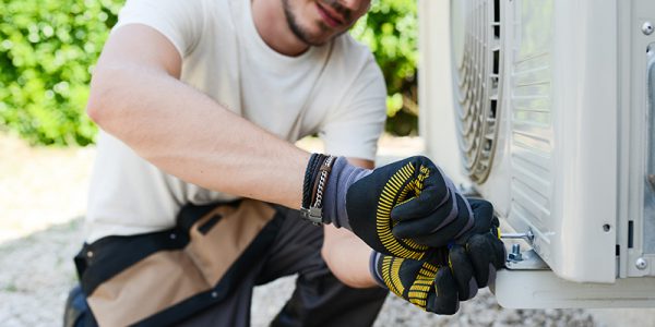 Canva---handsome-young-man-electrician-installing-air-conditioning-in-client-house